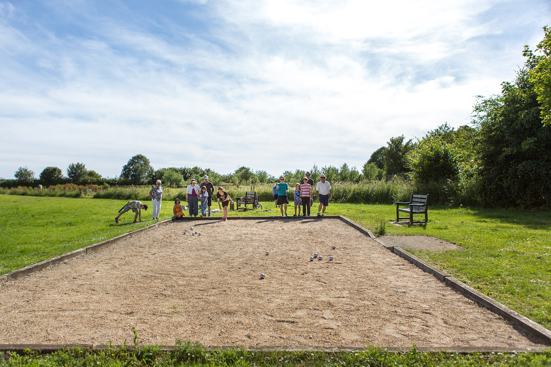 Families playing on the Pétanque area in Holmead Walk Gardens